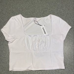 This cropped white top is a great basic piece, perfect to match accessories!